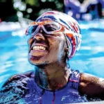 Special Olympics gold medal athlete and Motivational Speaker African American Ashton Smith smiling in a pool