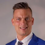 Ryan Listerman corporate business sales trainer for hire in a blue suit.