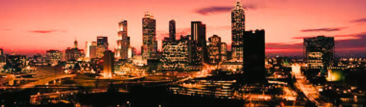 Distorted Atlanta skyline at night with orange and pink hues.