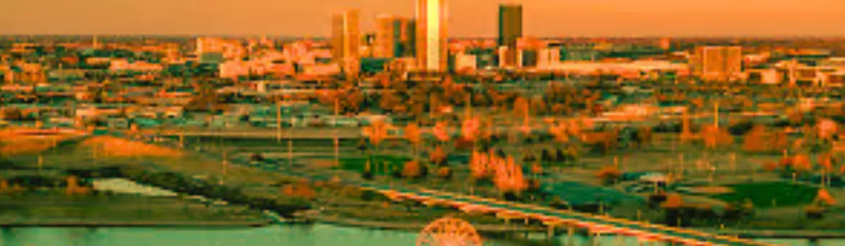 Distorted sand image of the OKC skyline with the Oklahoma River in the foreground.