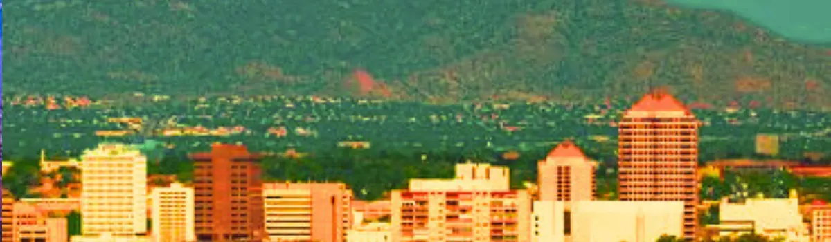 Distorted image of Albuquerque skyline with Sandia Mountains in background.