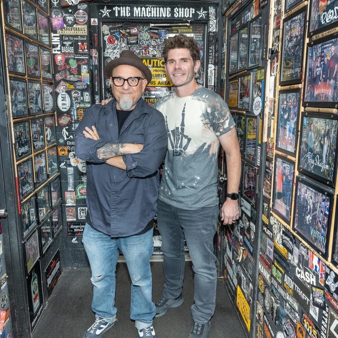 Comedians for hire Bobcat Goldthwait and Dustin Cole posing inside The Machine Shop.